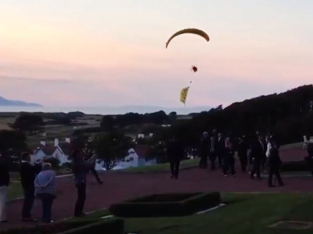 Protester paraglides over Trump, gets away