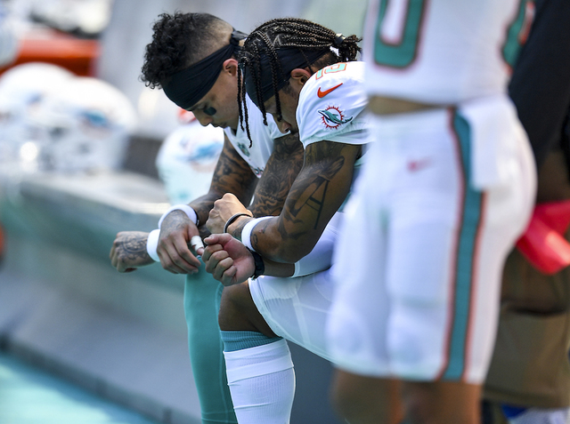 Two Miami Dolphins players kneel during national anthem